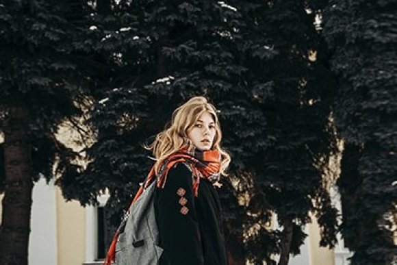 woman in fashionable winter coat and scarf